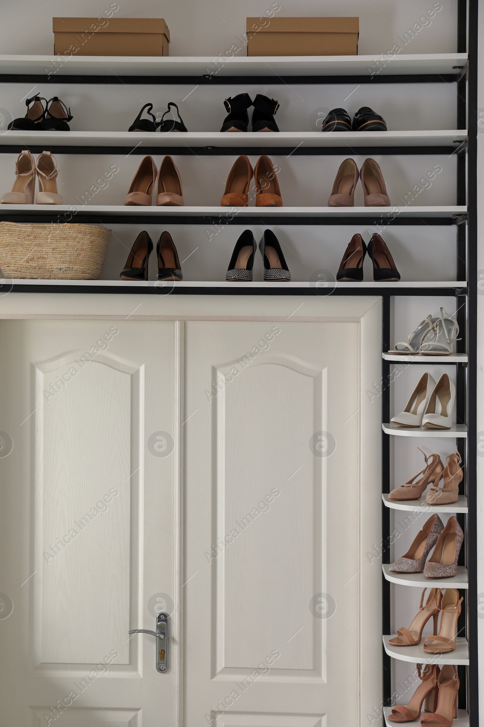 Photo of Dressing room interior with storage rack for shoes and accessories