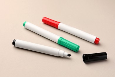 Bright color markers on beige background. Office stationery
