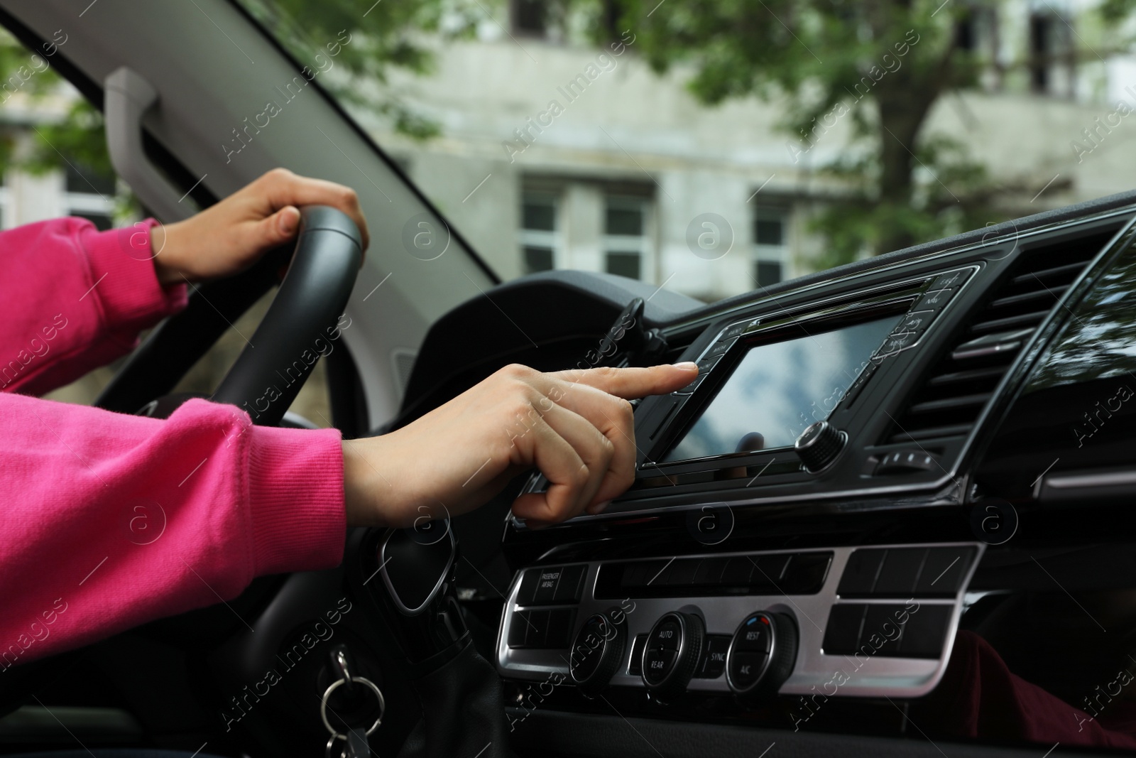 Photo of Woman using navigation system while driving car, closeup