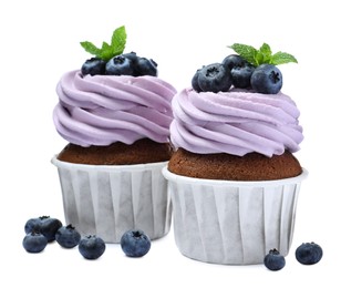 Photo of Sweet cupcakes with fresh blueberries on white background