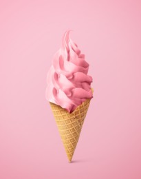 Image of Tasty raspberry or strawberry ice cream in waffle cone on pastel pink background. Soft serve