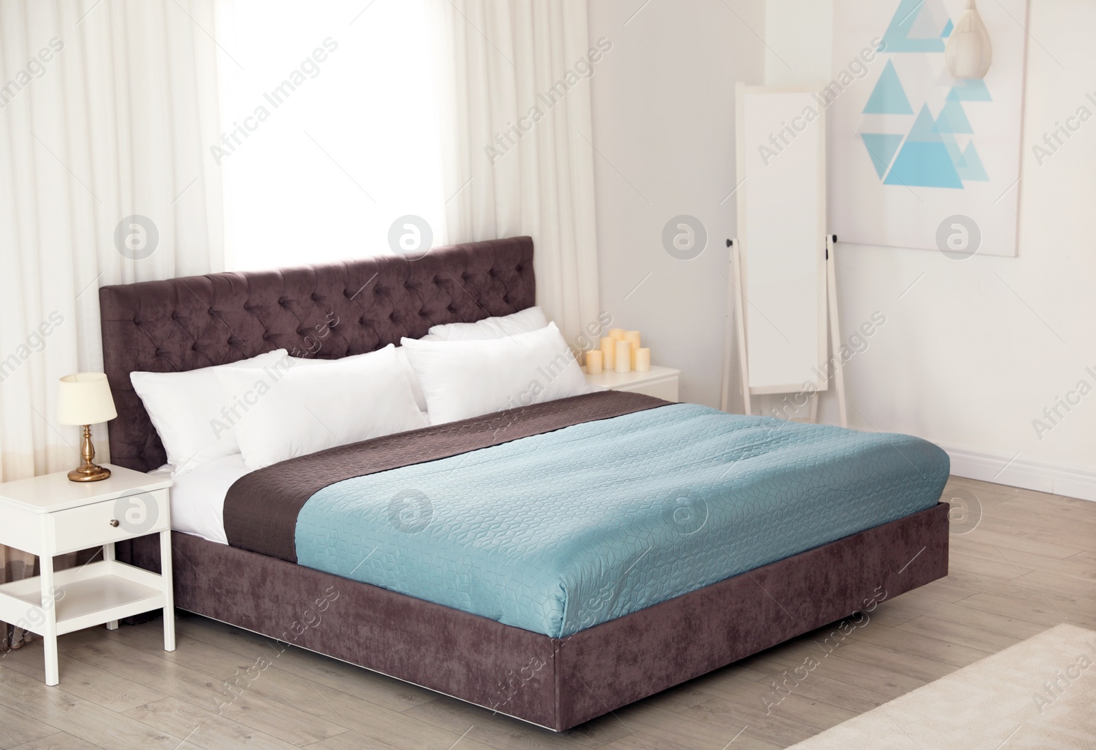 Photo of Modern comfortable bed in room. Interior design