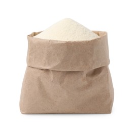 Photo of Paper bag with uncooked organic semolina isolated on white