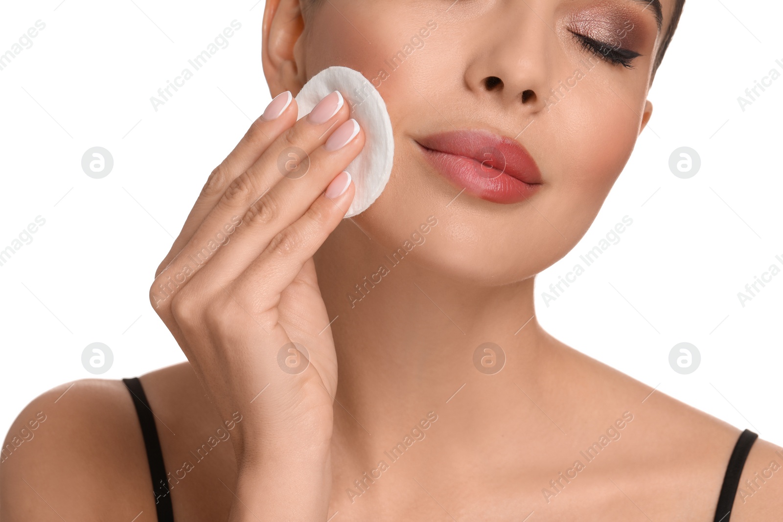 Photo of Beautiful woman removing makeup with cotton pad on white background, closeup