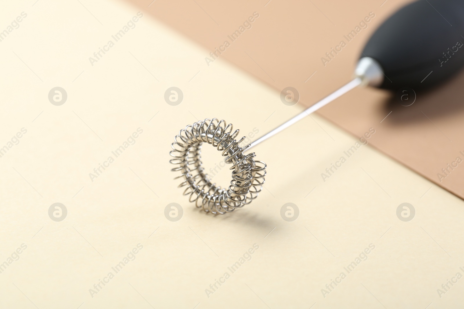 Photo of Black milk frother wand on color background, closeup. Space for text