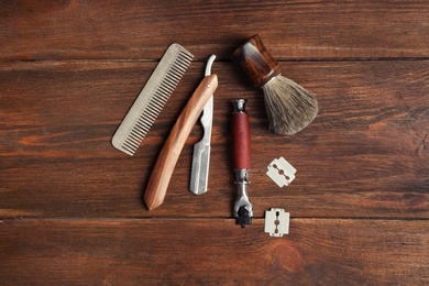Photo of Flat lay composition with shaving accessories for men on wooden background