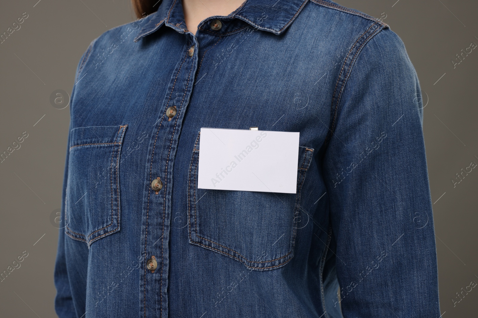 Photo of Woman with blank badge on grey background, closeup