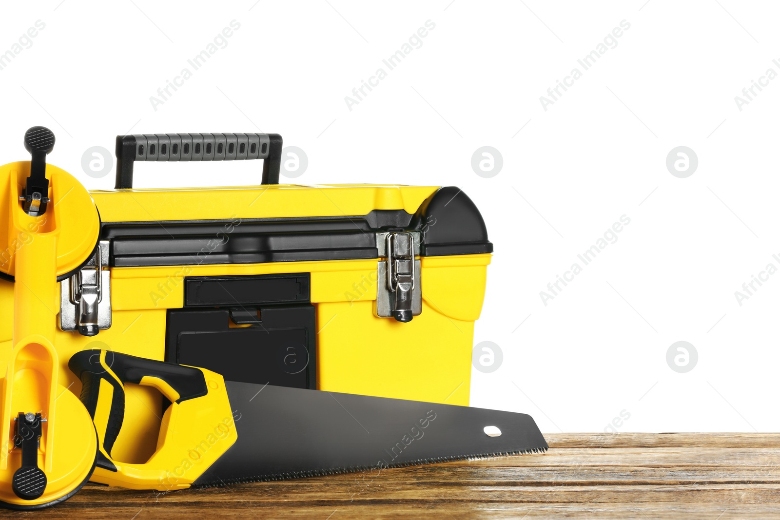 Photo of Plastic box with different tools on wooden table against white background