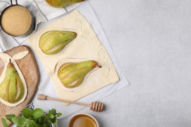 Photo of Raw dough with fresh pears, honey and mint on white table, flat lay. Space for text