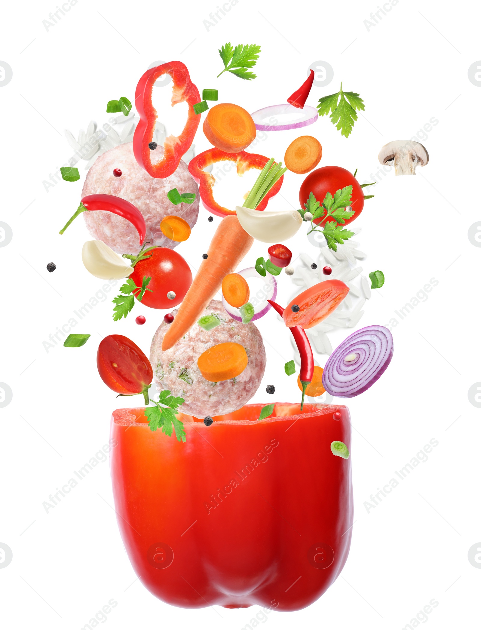 Image of Stuffed pepper recipe. Fresh ingredients falling into bell pepper on white background