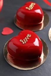 Photo of St. Valentine's Day. Delicious heart shaped cakes and confetti on black table, closeup