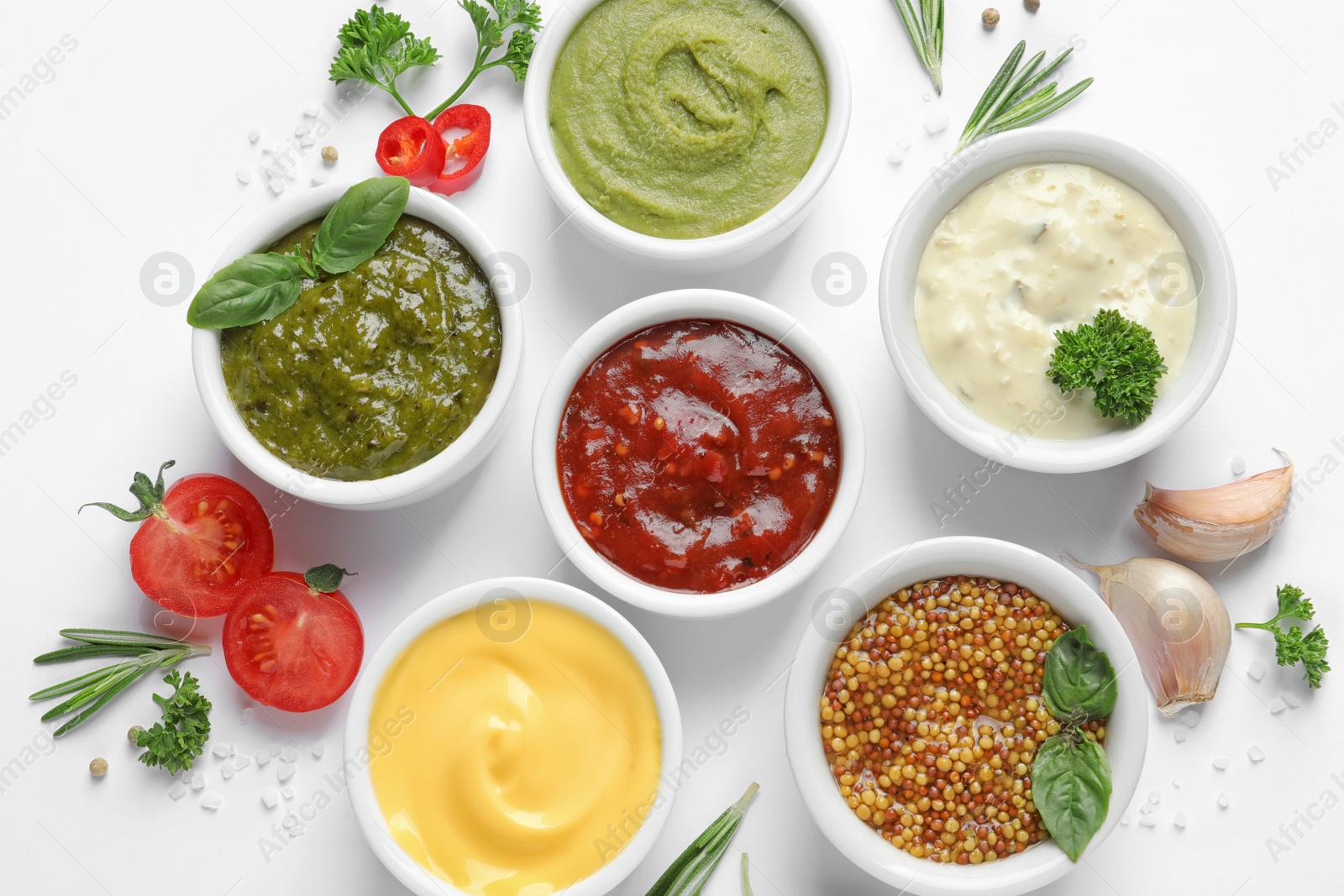 Photo of Composition with different sauces and ingredients on white background, flat lay