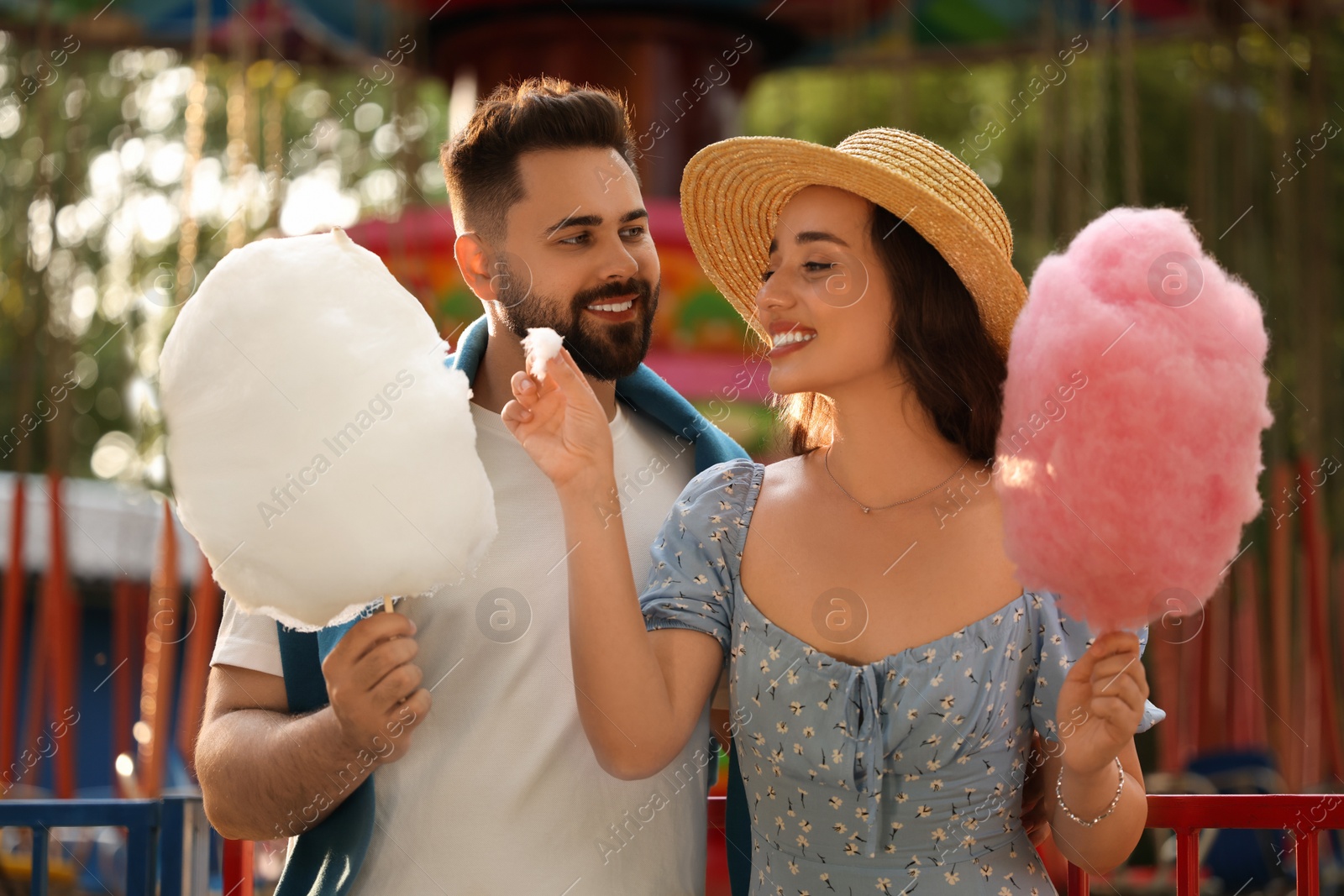 Photo of Happy couple with cotton candies at funfair