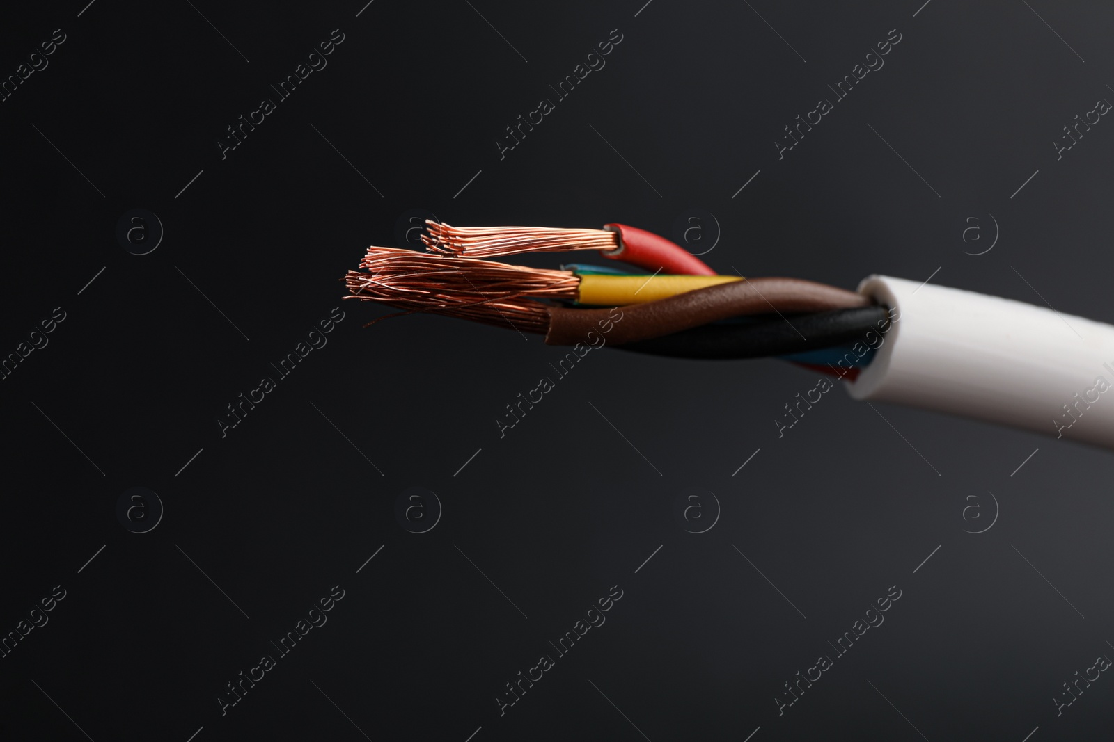Photo of Cable with electrical wires on black background, closeup