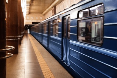 Photo of Modern subway station with blue train. Public transport