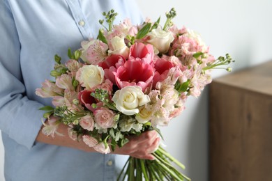 Woman with beautiful bouquet of fresh flowers indoors, closeup