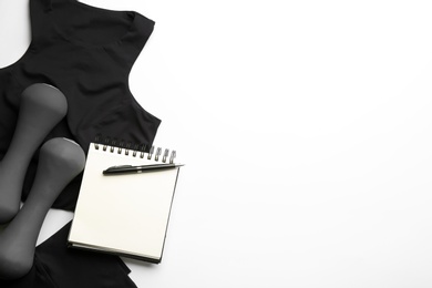 Photo of Sportswear, notebook and dumbbells on white background, flat lay. Gym workout plan