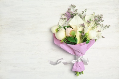 Photo of Bouquet of beautiful fragrant flowers on wooden background