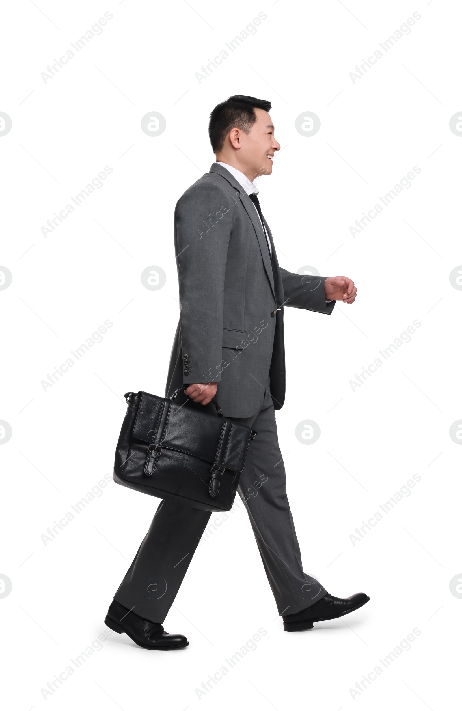 Photo of Businessman with briefcase walking on white background