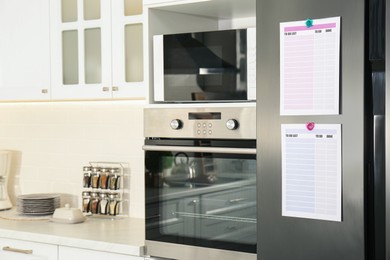 Photo of To do lists with magnets on refrigerator indoors. Space for text