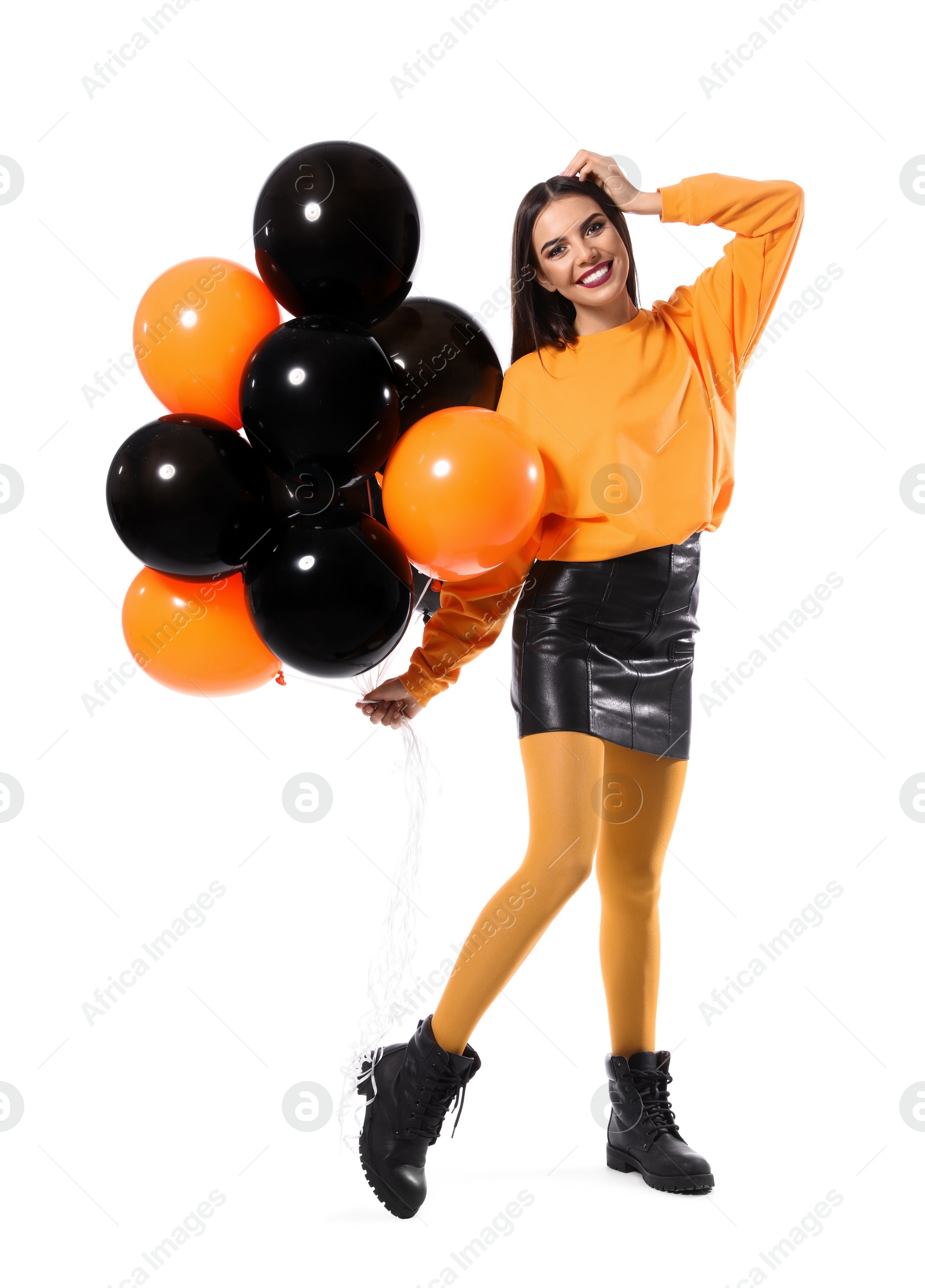 Photo of Beautiful woman with balloons on white background. Halloween party