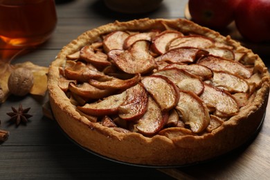 Photo of Delicious apple pie on wooden table, closeup