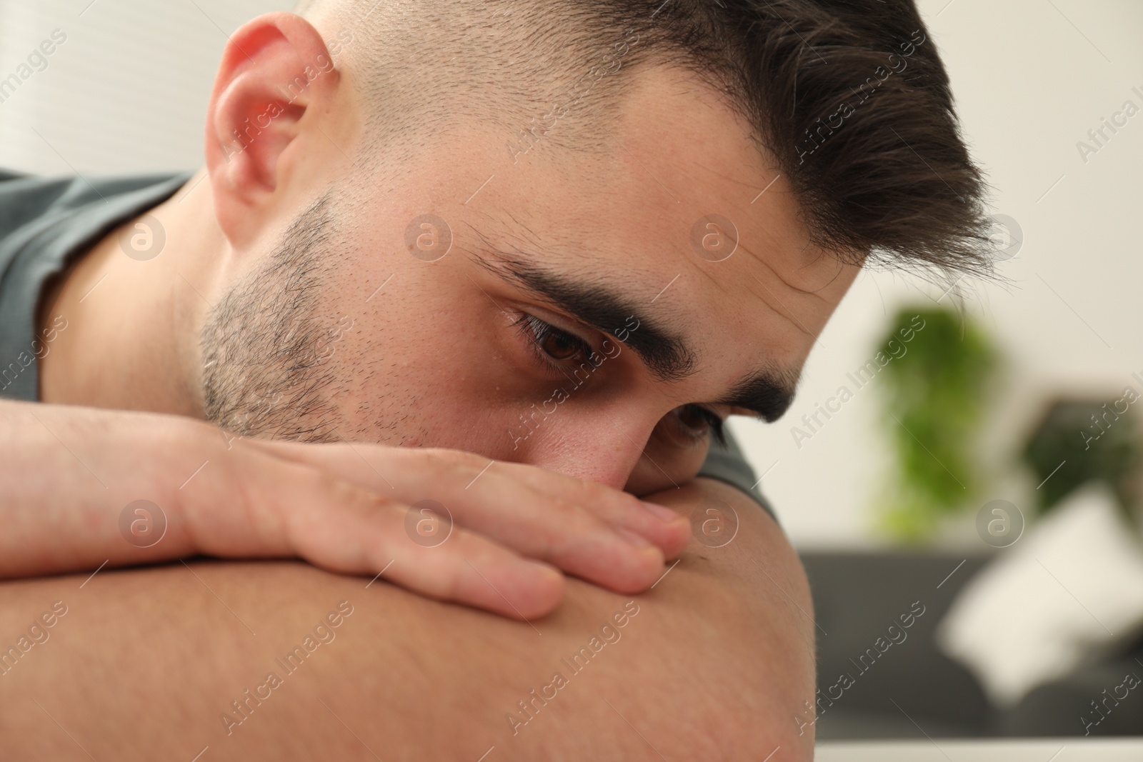 Photo of Portrait of sad man on blurred background, closeup