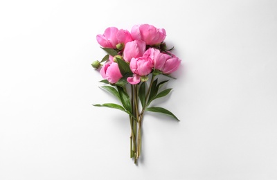 Photo of Fragrant peonies on white background, top view. Beautiful spring flowers