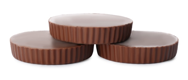 Delicious peanut butter cups on white background