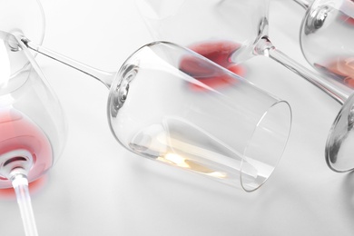 Glasses with different wine on white background, closeup