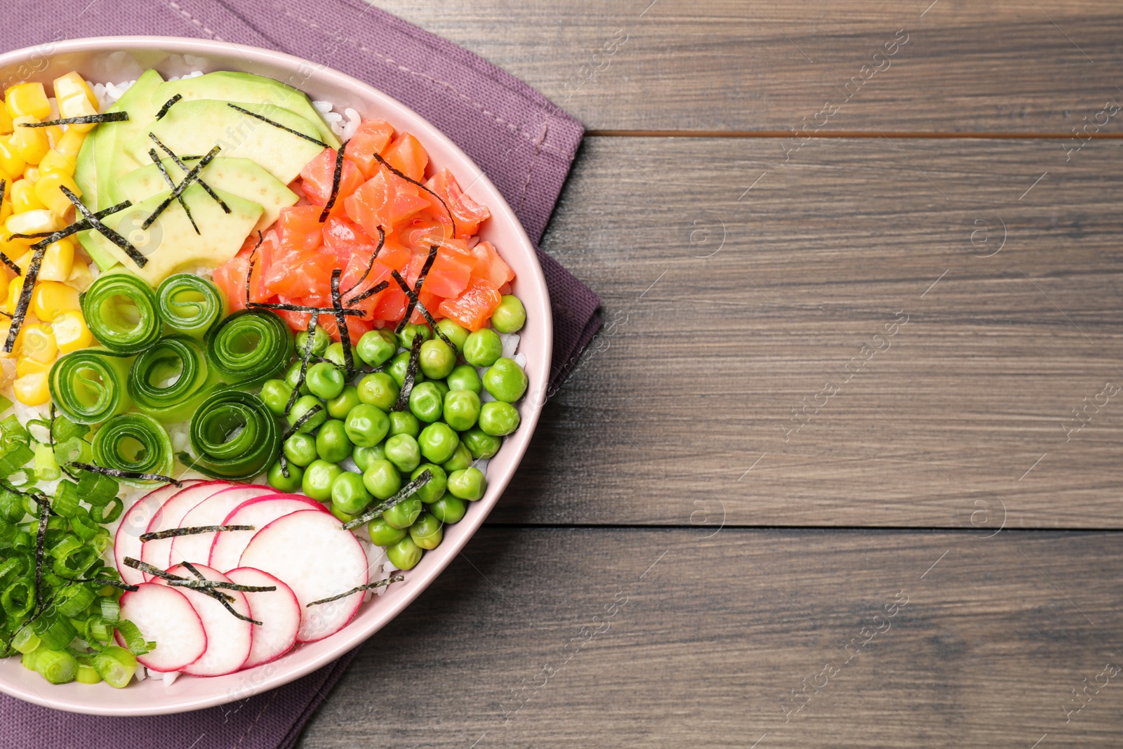 Photo of Delicious salad with salmon and vegetables on wooden table, top view. Space for text