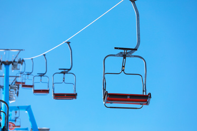 Photo of Empty chairlift at mountain ski resort. Winter vacation