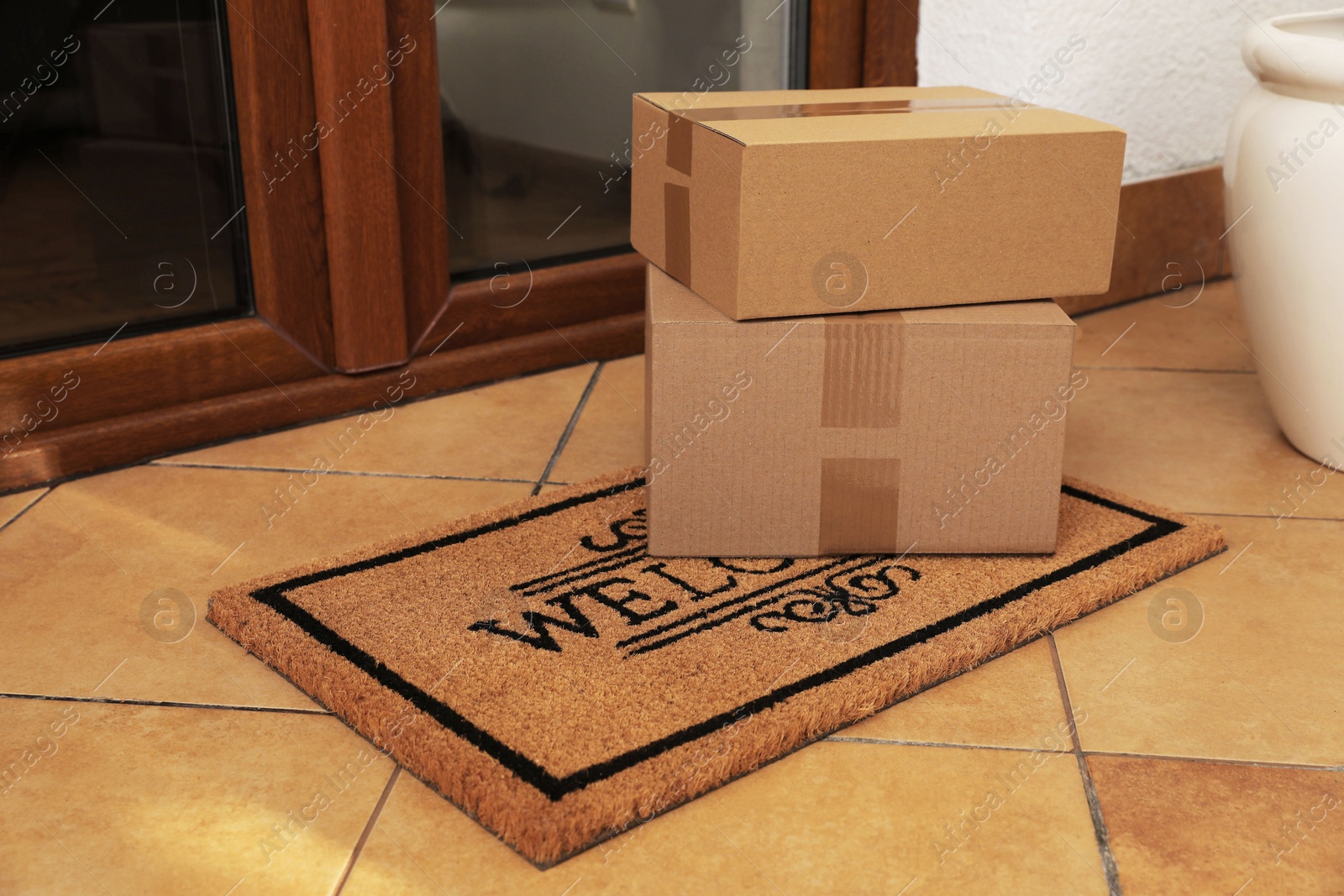 Photo of Parcels delivered on mat near front door