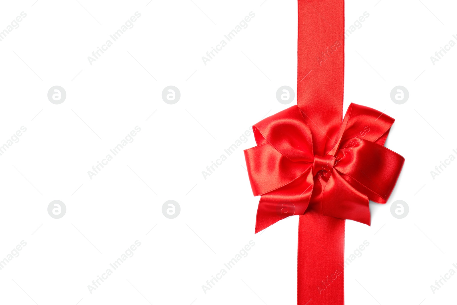 Photo of Red ribbon with bow on white background. Festive decoration