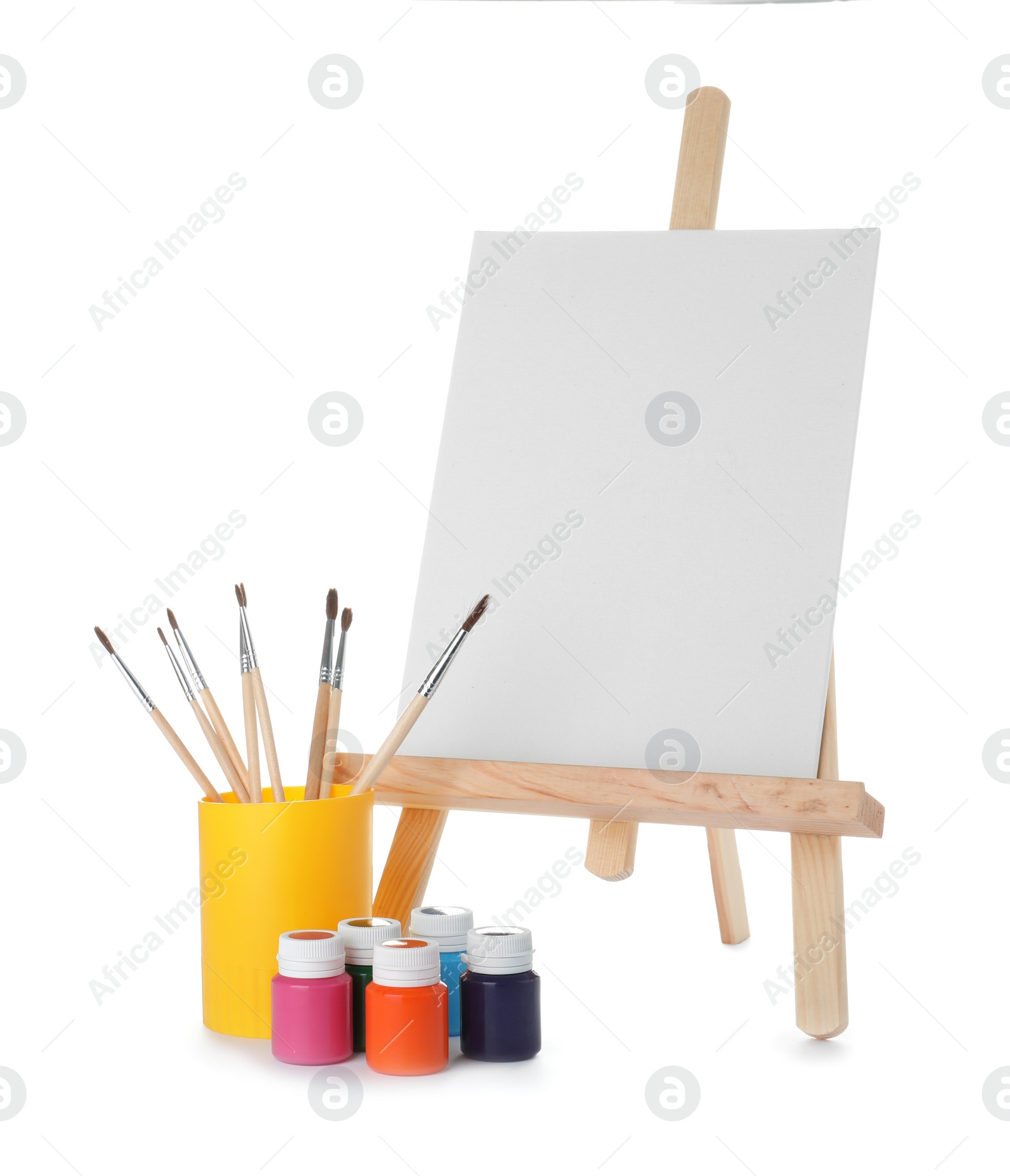 Photo of Wooden easel with blank canvas board and painting tools for children on white background