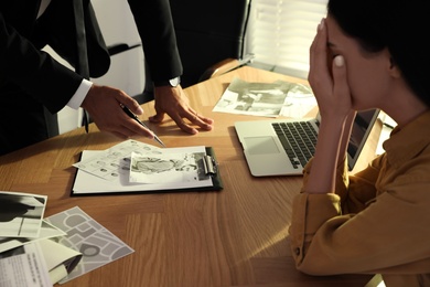 Detective working with client in his office