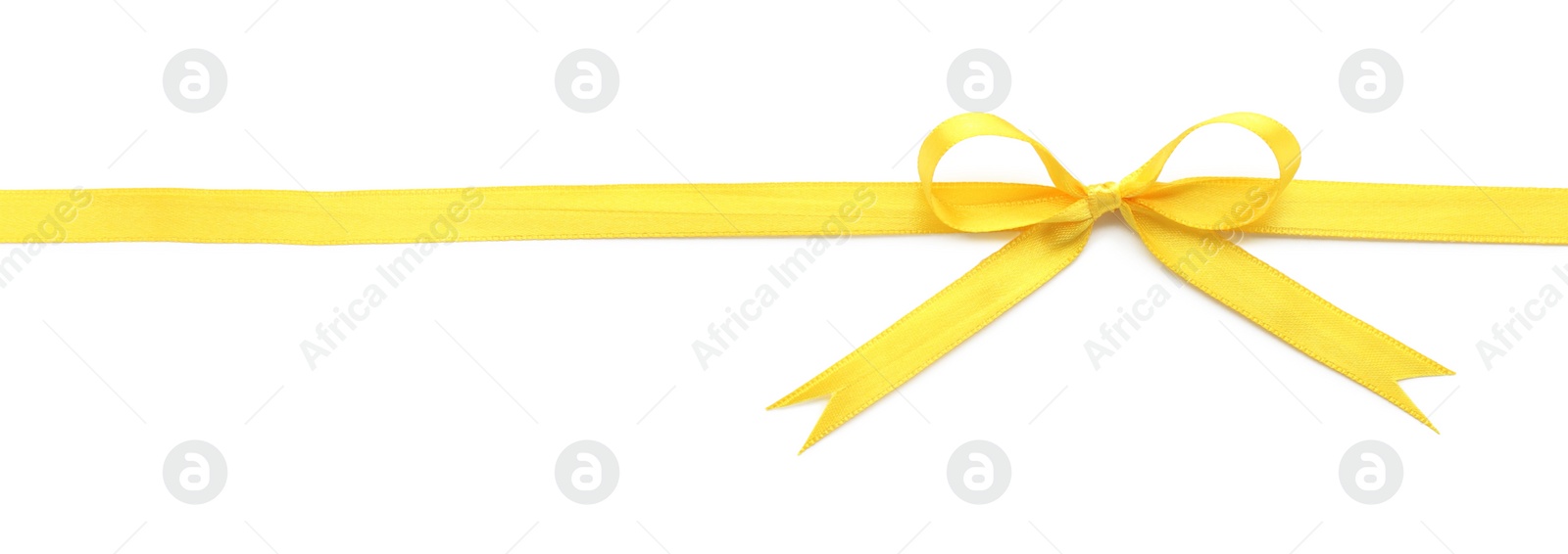 Photo of Yellow satin ribbon with bow on white background, top view