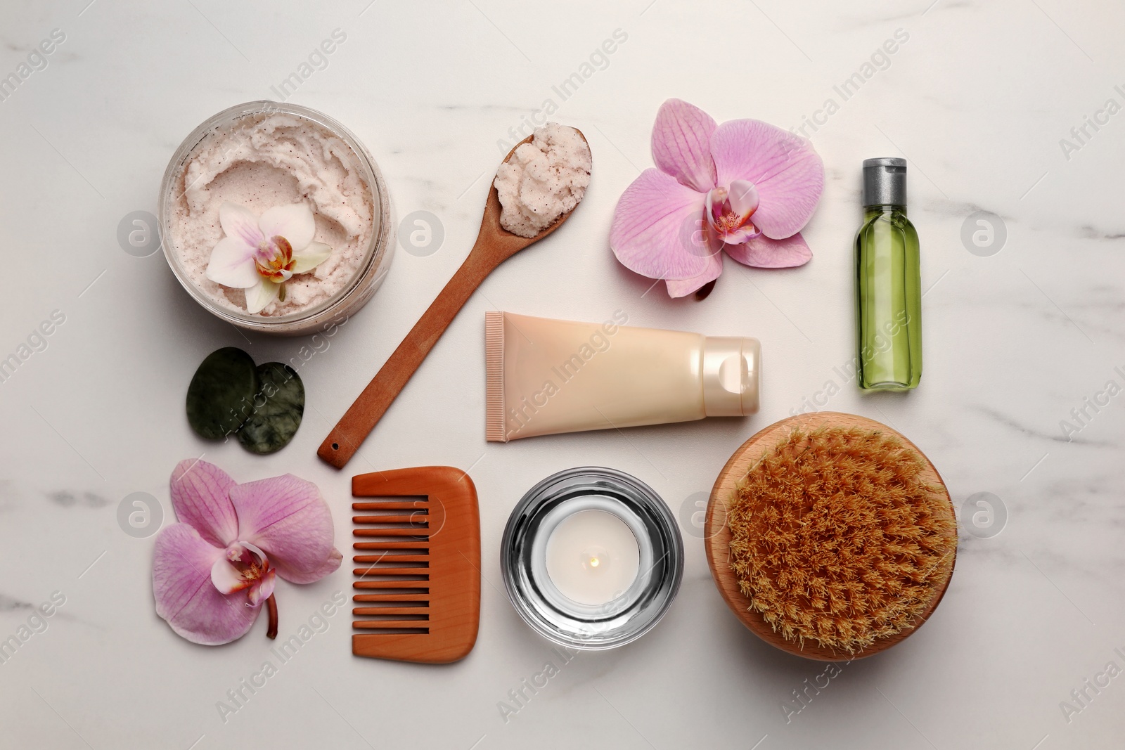 Photo of Flat lay composition with different spa products and flowers on white marble table