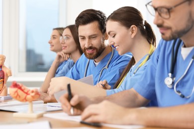 Medical students in uniforms studying at university