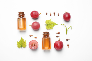 Photo of Flat lay composition with natural grape seed essential oil on white background. Organic cosmetics