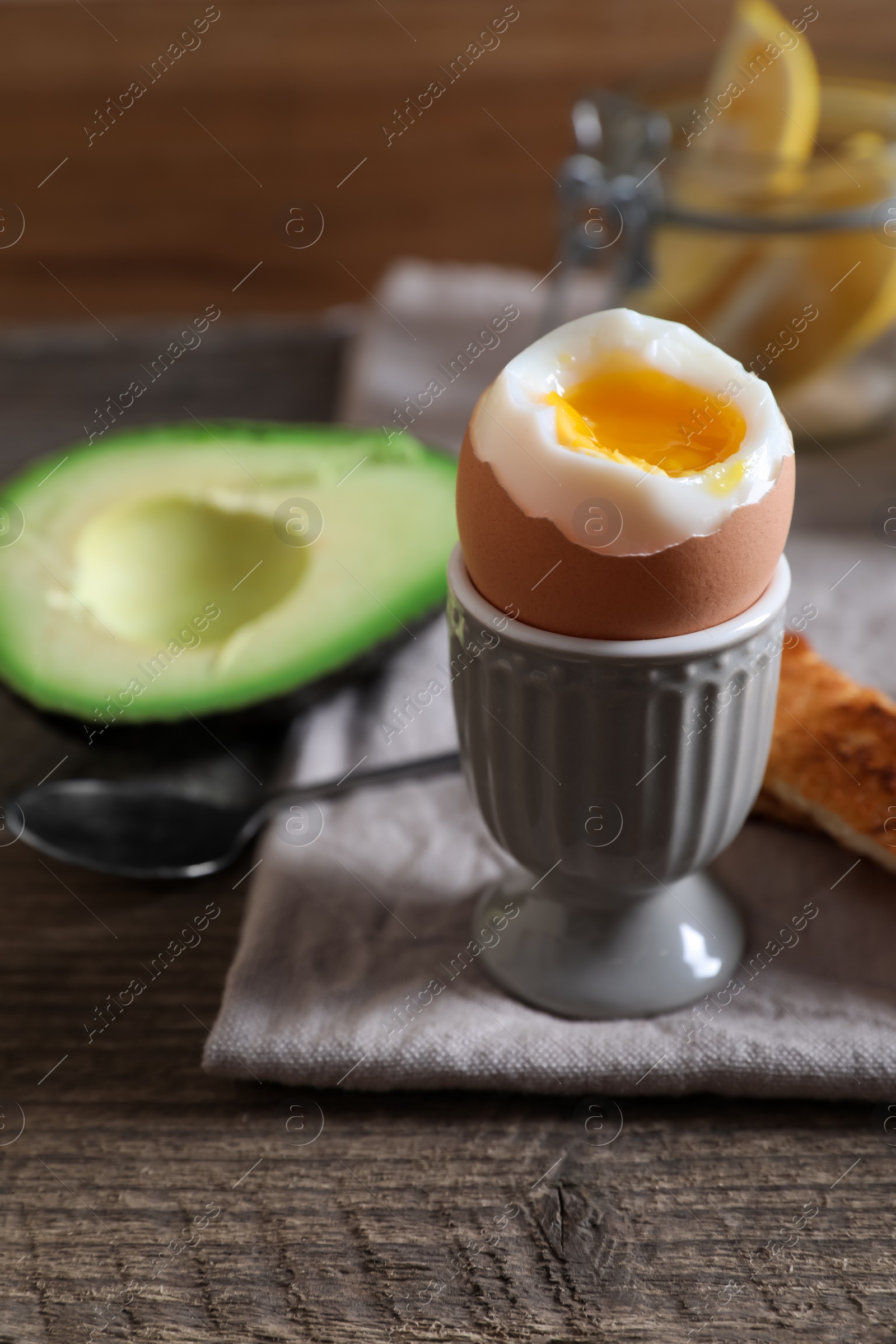 Photo of Soft boiled egg served for breakfast on wooden table