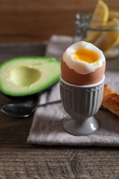 Photo of Soft boiled egg served for breakfast on wooden table