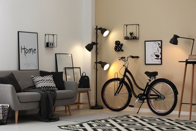Photo of Modern living room interior with comfortable sofa and bicycle