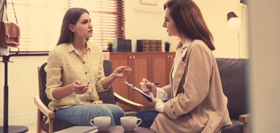 Image of Professional psychotherapist working with patient in office. Banner design
