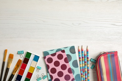 Photo of Different school stationery with space for design on wooden background, flat lay