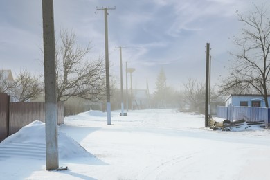 Photo of Picturesque view of street covered with snow on winter day