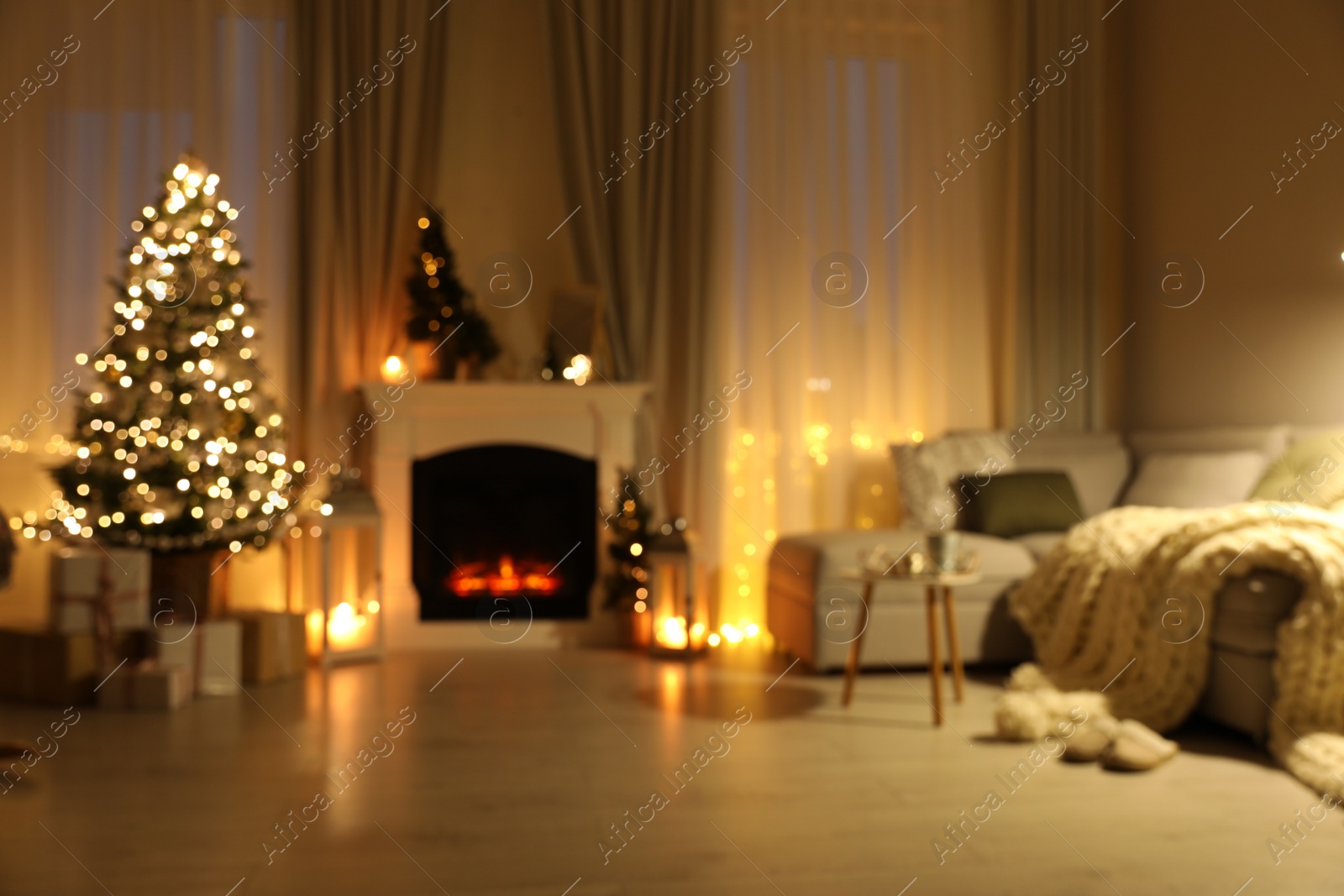 Photo of Stylish living room interior with Christmas tree near beautiful fireplace, blurred view