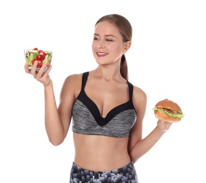 Slim woman with burger and salad on white background. Healthy diet