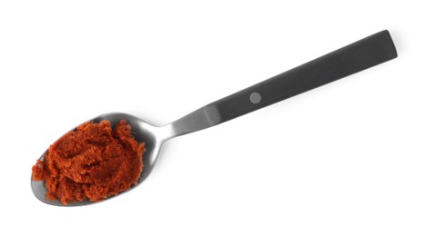 Tasty curry paste in spoon isolated on white, top view