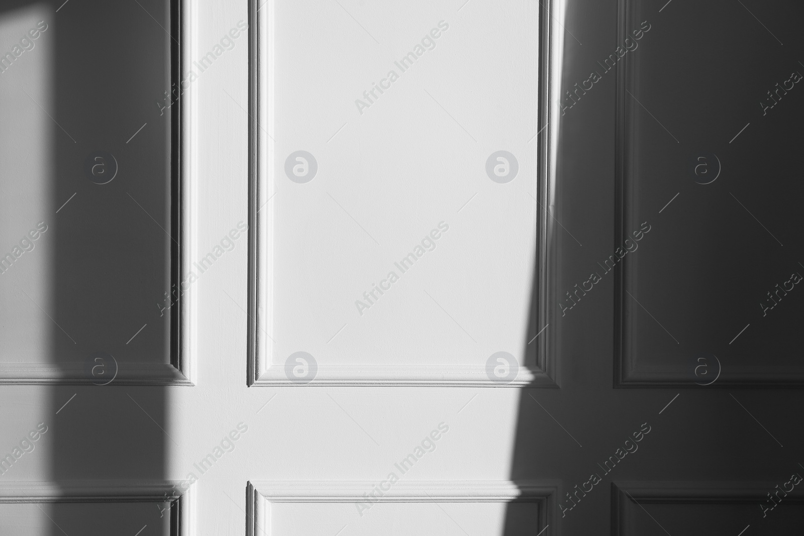 Photo of Light and shadow from window on beige wall indoors